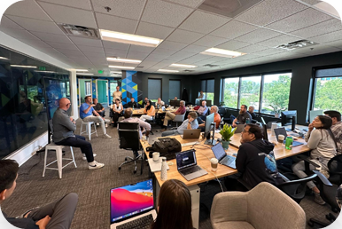 A Swimlane meeting of employees in an office space